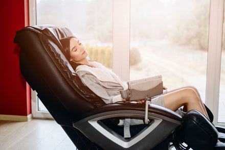 Woman relaxing in her massage chair as the sun gently streams in through the large windows