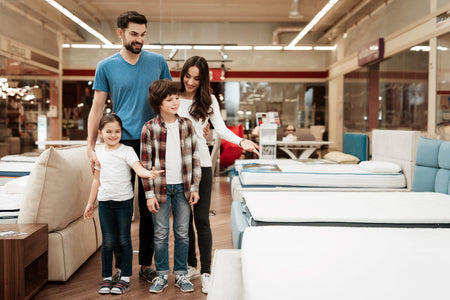 A family looking for mattress in a mattress store.