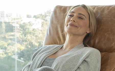 Smiling woman resting in a massage chair