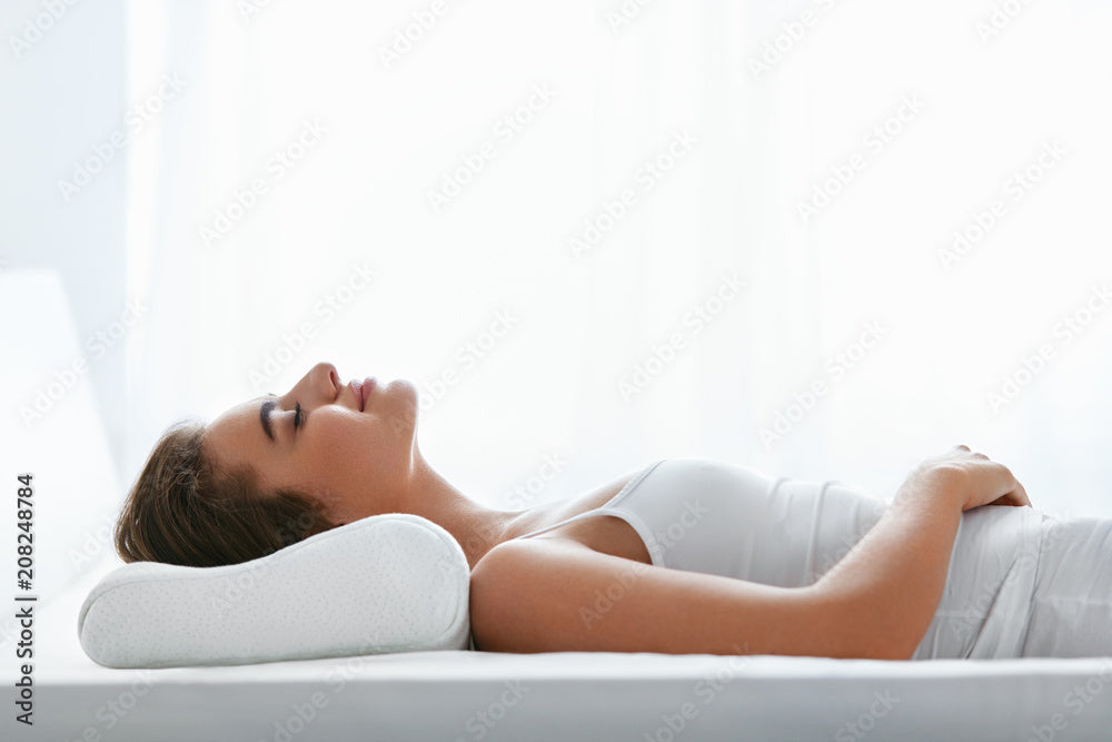 Young woman sleeping on orthopedic pillow.